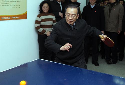 这是1月1日,温家宝在青岛仙游路社区服务中心看望社区居民时打乒乓球。新华社记者 姚大伟 摄